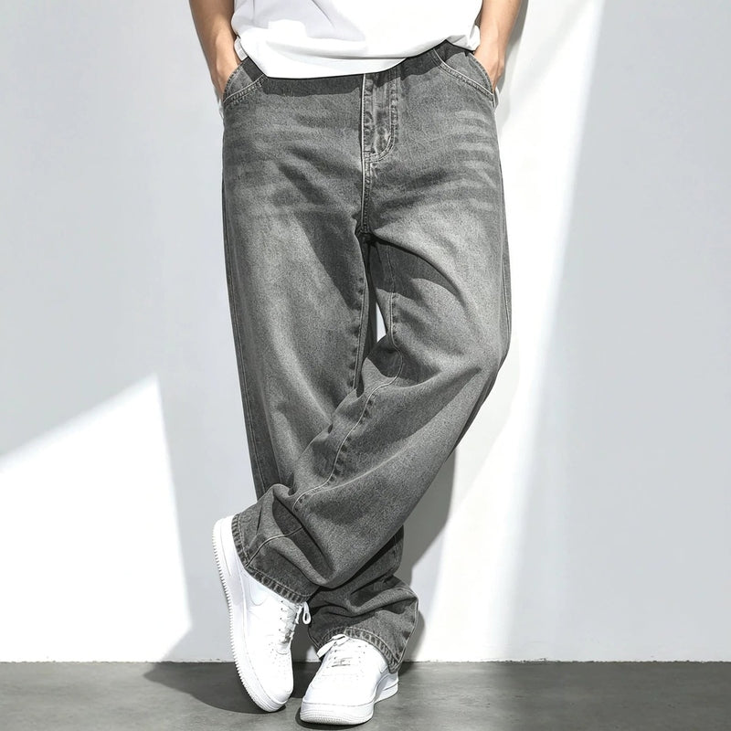 Men's gray washed jeans styled with hands in pockets highlighting casual fit and texture