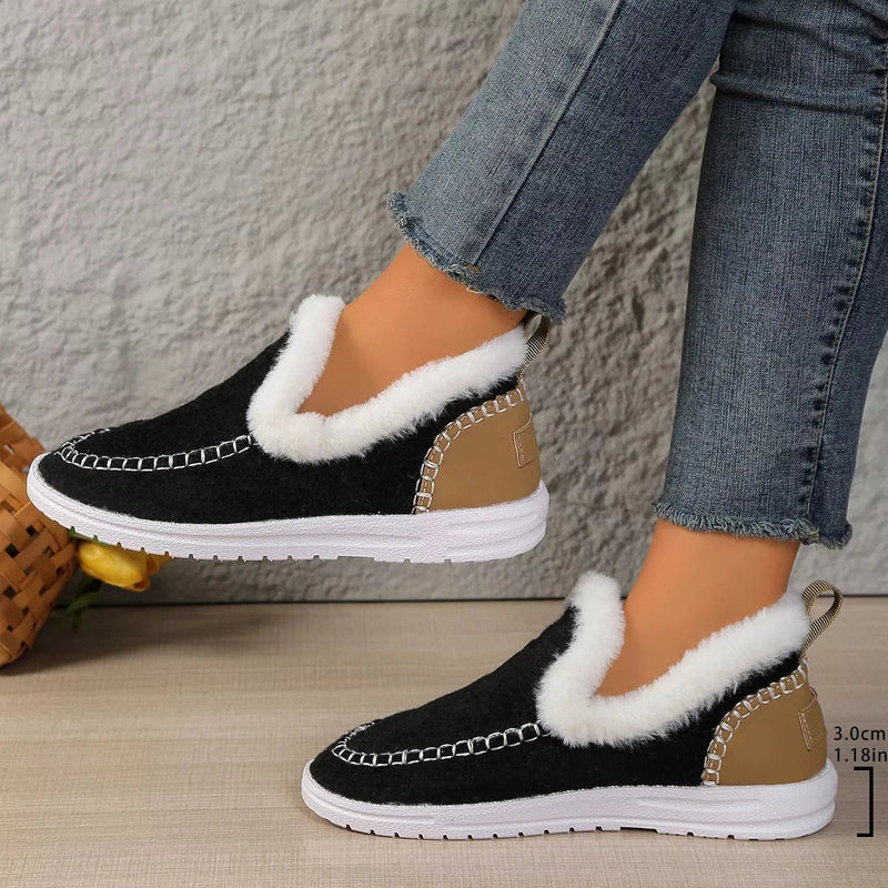 Black plush-lined slip-on shoes with white fuzzy trim and rubber soles