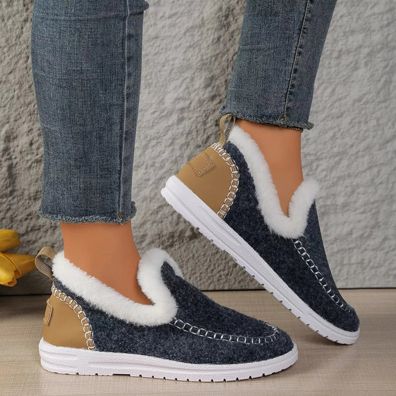 Dark blue plush-lined women's slip-on flats with white fluffy collar and rubber sole