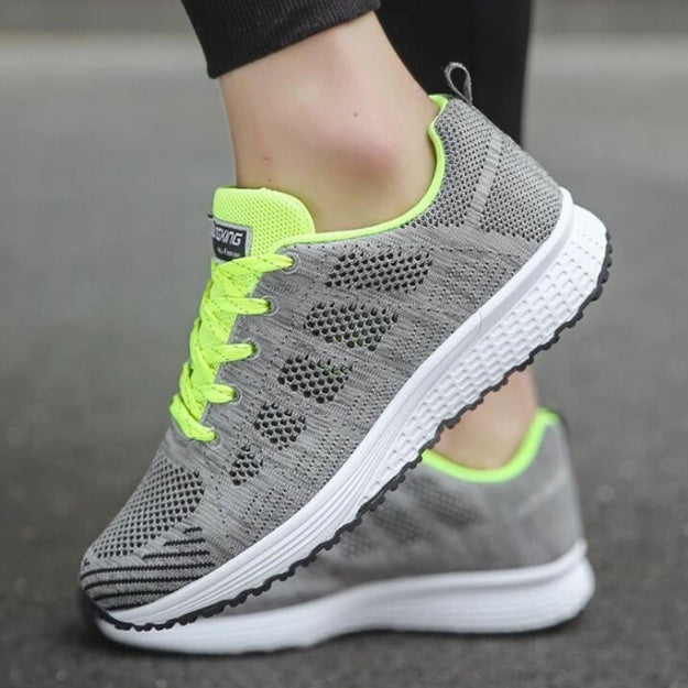 Grey mesh sneakers with neon green laces and bright accent lining