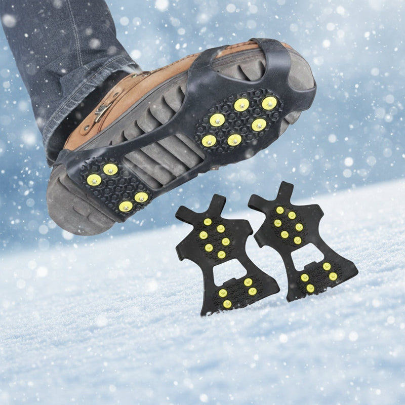 Brown boot with black crampon traction cover on snowy terrain