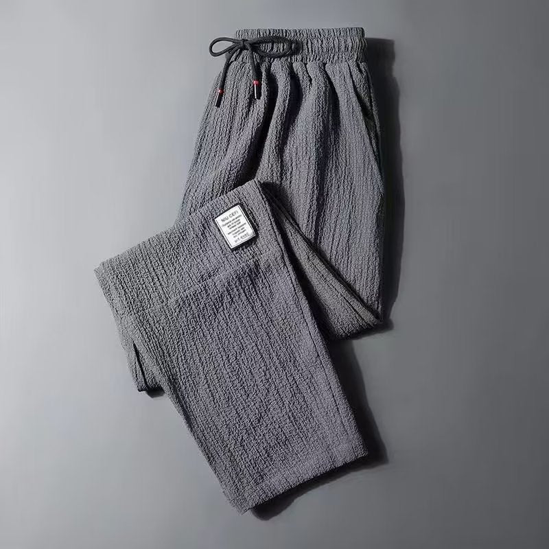 Grey men's casual cropped straight-leg trousers featuring textured fabric and elastic waistband