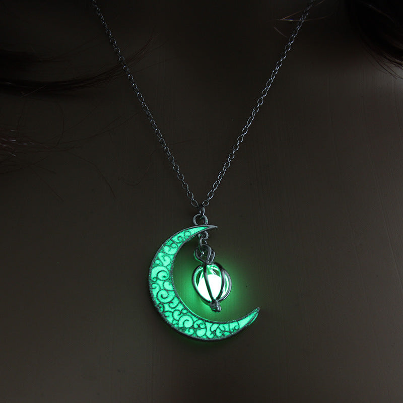 Green glowing pumpkin pendant necklace with silver crescent moon filigree