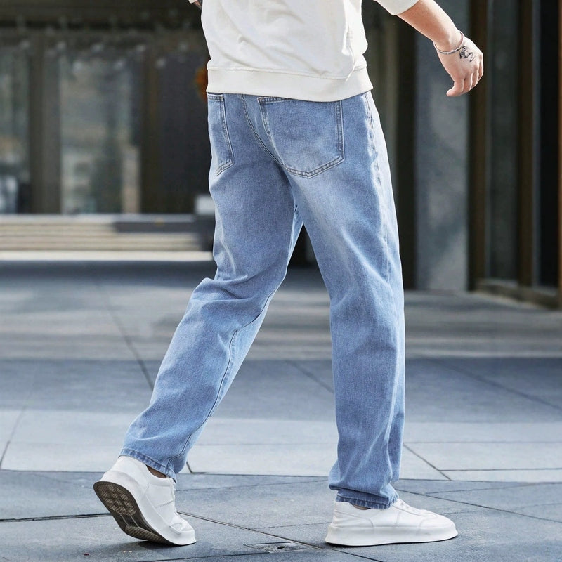 Men's blue vintage washed denim jeans rear view showing back pockets and orange stitching
