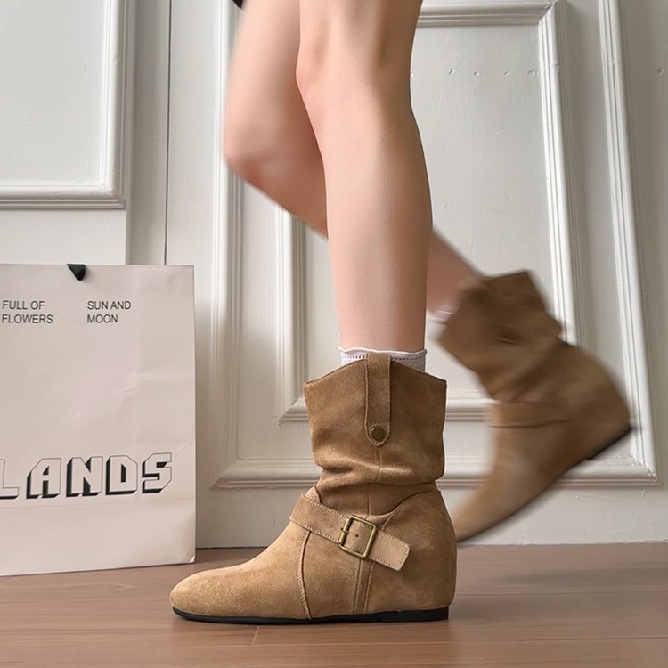 camel suede slouchy boot with ankle buckle worn while walking