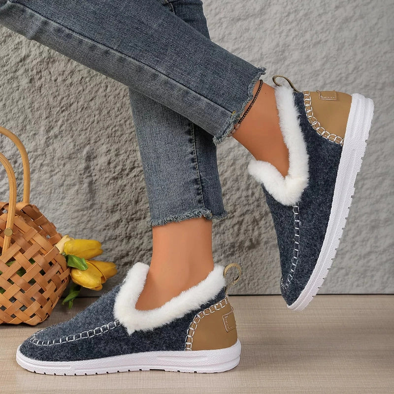 Side view of cozy dark blue slip-on shoes with silver stitching detail