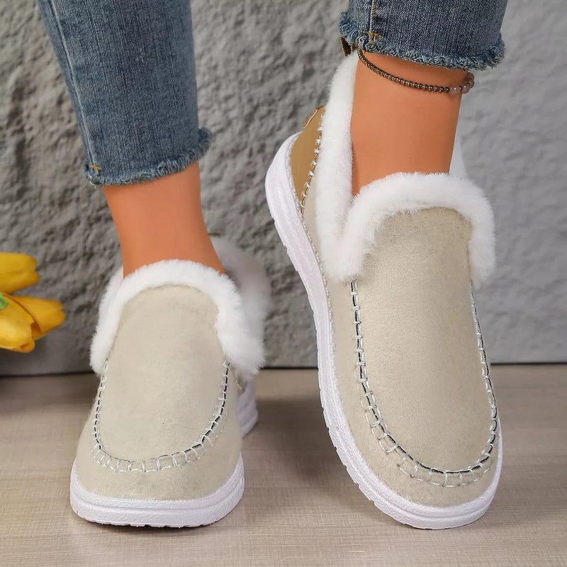 Front view of beige slip-ons with silver-toned toe box stitching