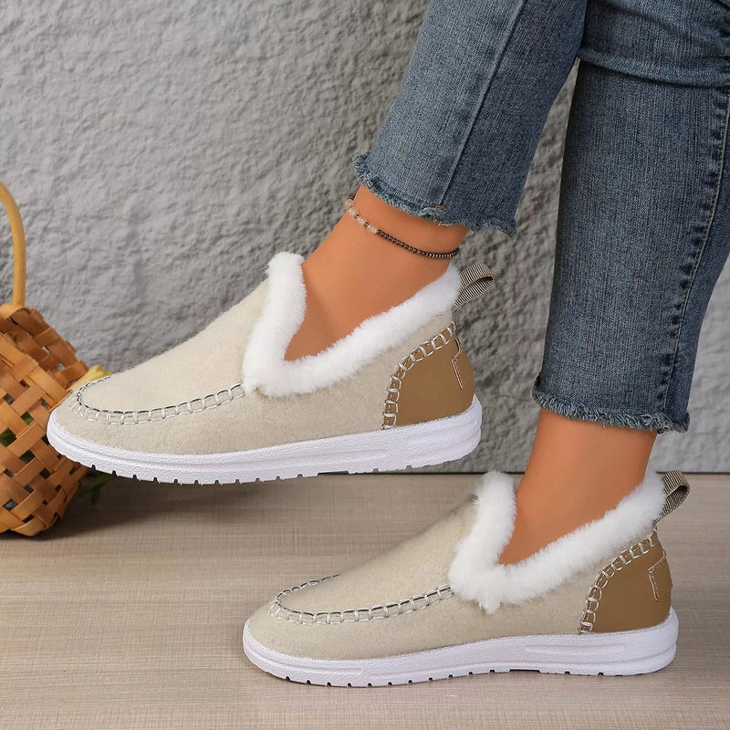 Off-white slip-on flats with metallic moccasin-style stitching