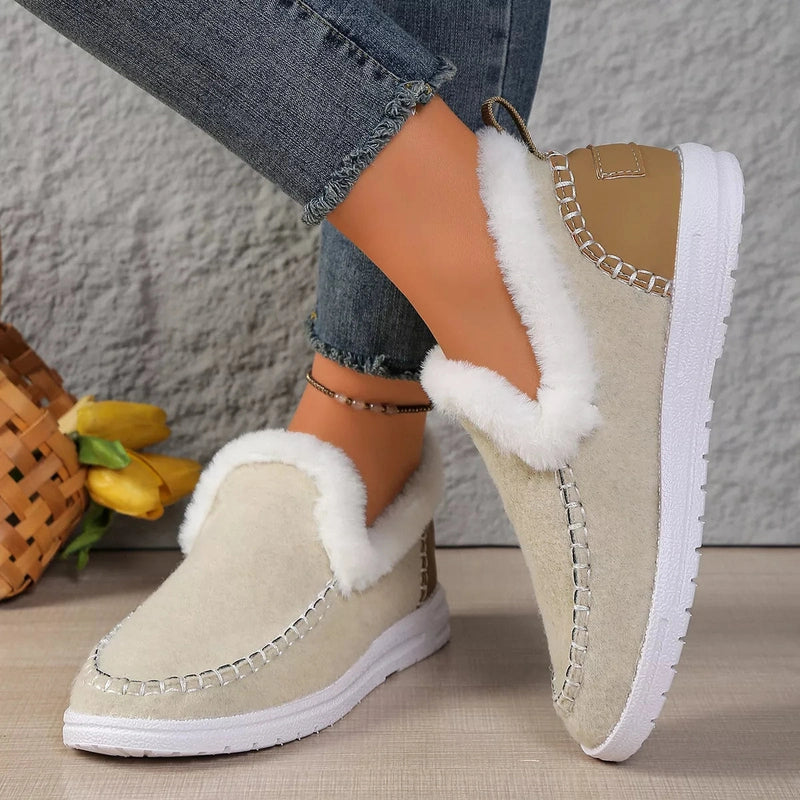 Model wearing beige plush-lined slip-ons with tan heel accents