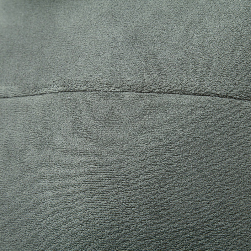 Macro shot of textured olive polyester knit construction and horizontal splicing seam