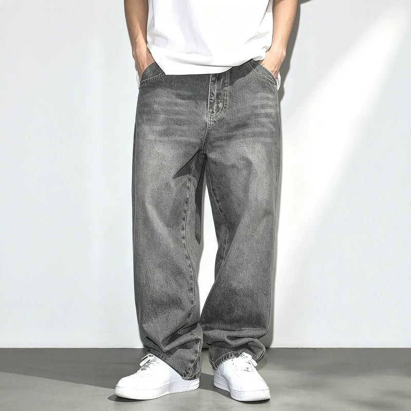 Men's gray distressed washed jeans with loose straight fit and vintage thigh fading