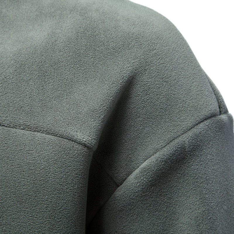 Close-up of grey-green fleece texture and precise stitching on men's sweatshirt shoulder
