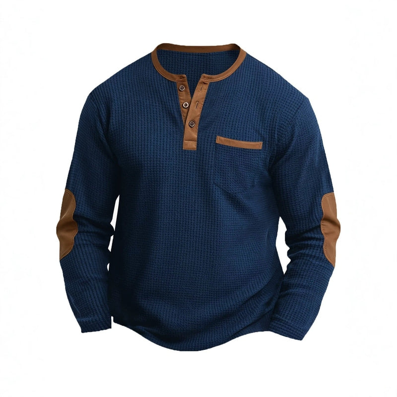 Navy blue waffle-knit long sleeve henley shirt with brown placket and chest pocket detail