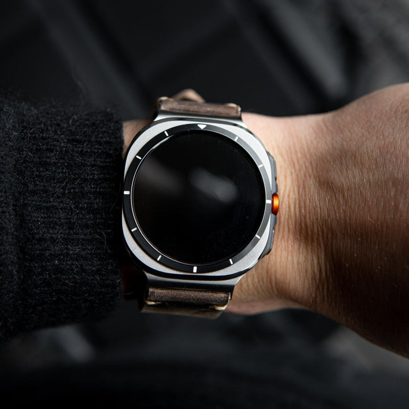 Wrist shot of silver smartwatch with distressed brown leather strap fit