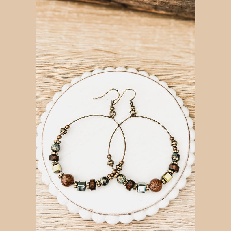 Bohemian hoop earrings with wood and teal beads on antique bronze frame