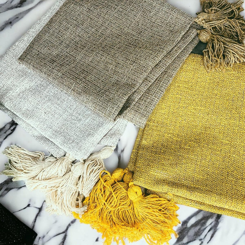 Gold, grey-brown, and cream linen pillow covers with thick knotted tassels