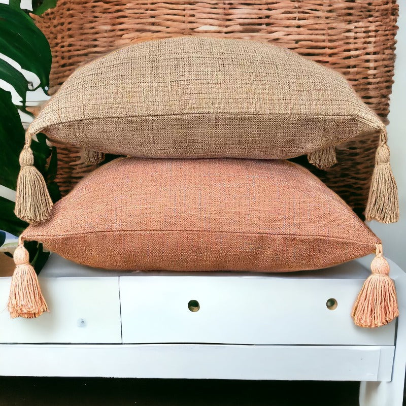 Tan and rust orange stuffed linen throw pillows with draping corner tassels