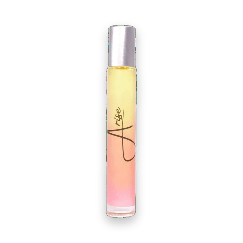 Arise rollerball perfume bottle showing yellow to pink gradient liquid