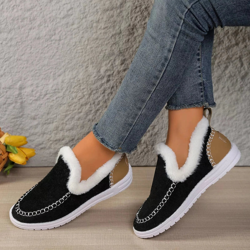 Black slip-ons with gold pull tab and silver chain-stitch vamp