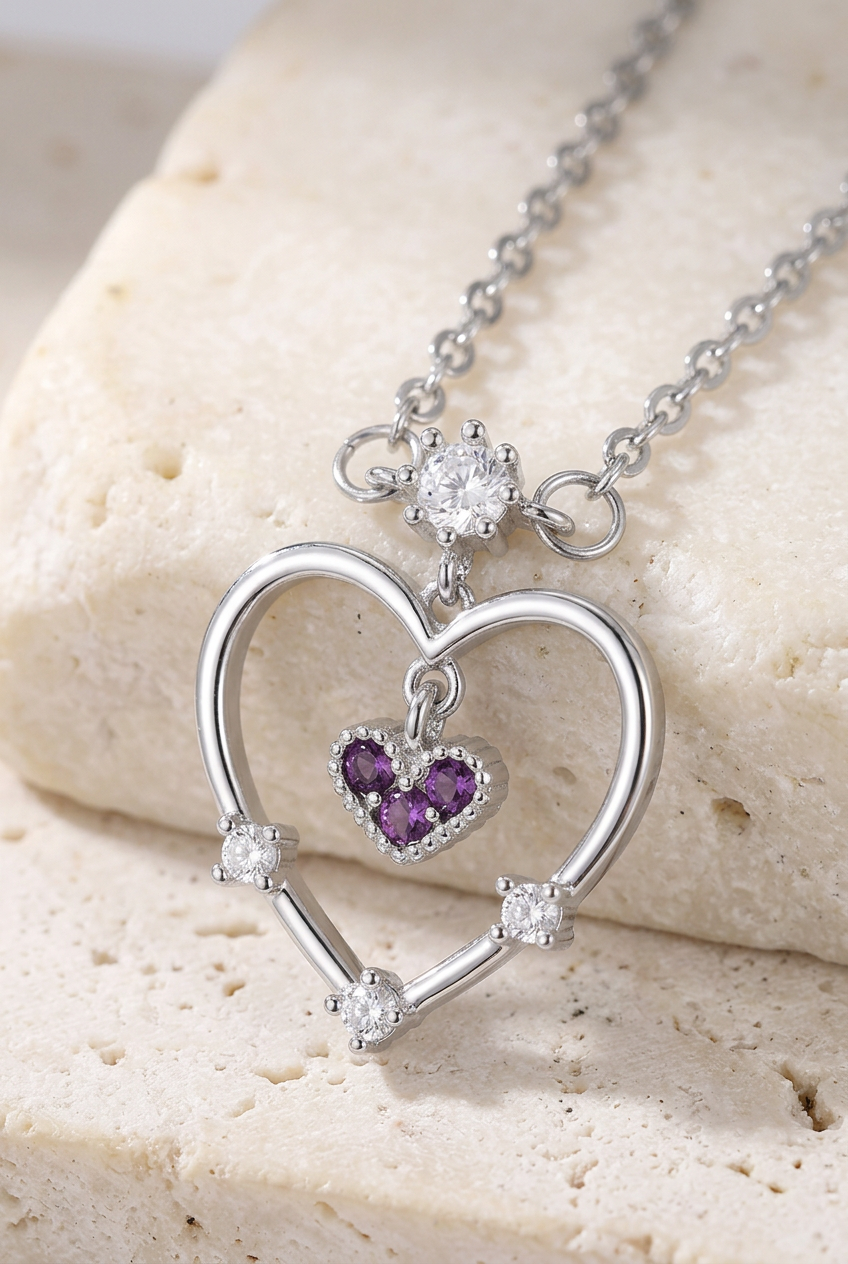 Close-up of the silver-tone heart and purple-stone charm