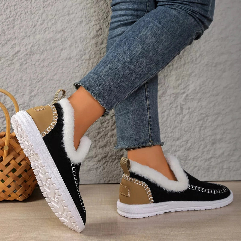 Rear view of black slip-ons showing textured white rubber sole pattern