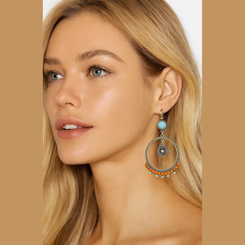 Close-up of vintage boho earring showing latch back closure, rope-textured rim, and rhinestone medallion