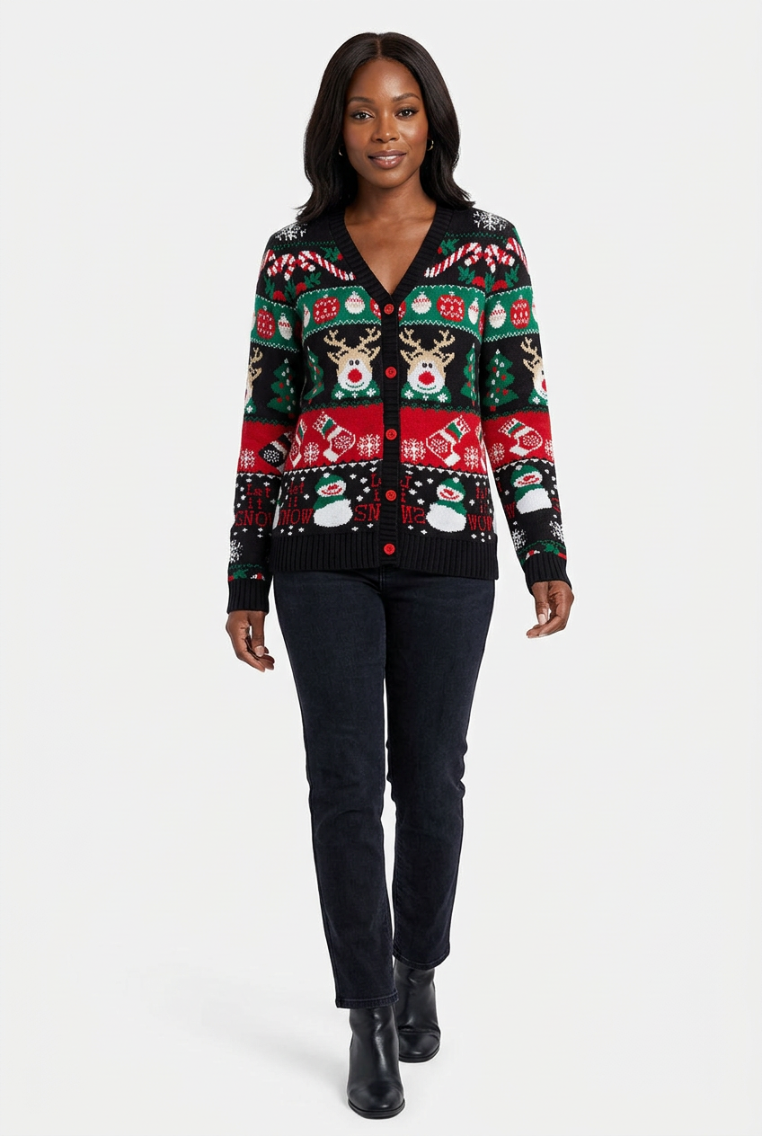 Full-length model wearing the black Holiday Rhythm Christmas cardigan with red buttons, festive reindeer and snowmen, dark jeans and black boots on white
