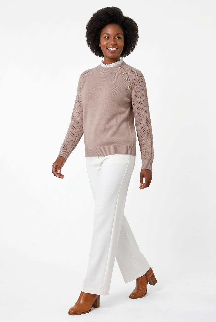Model wearing the dusty-pink Lace Signature eyelet-sleeve sweater with white trousers and brown boots on white