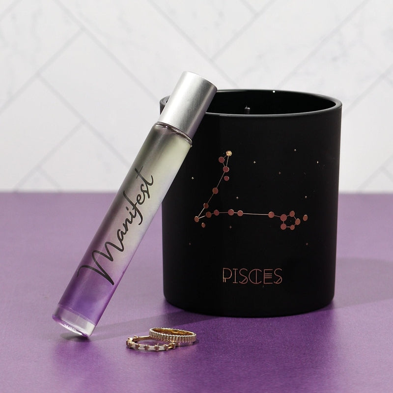 Manifest rollerball perfume with amber and vanilla notes in gradient purple glass bottle