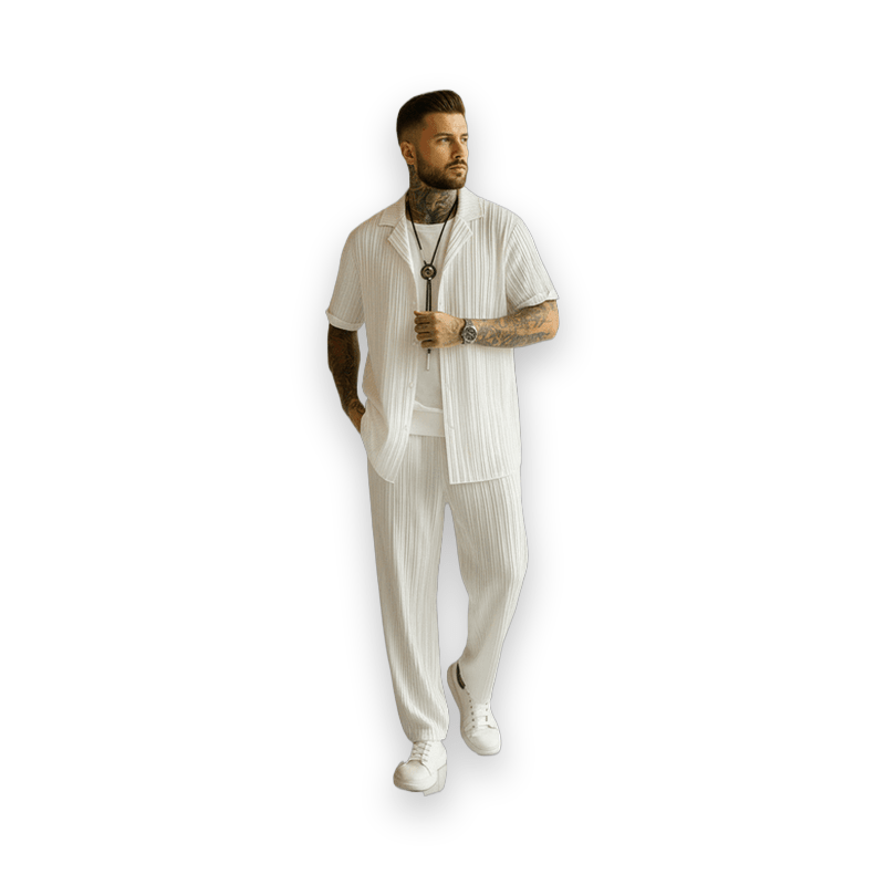 Man wearing white striped men's two-piece set walking in luxury lobby