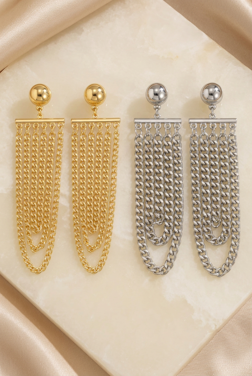 Silver-tone and gold-tone chain earrings styled on ivory stone