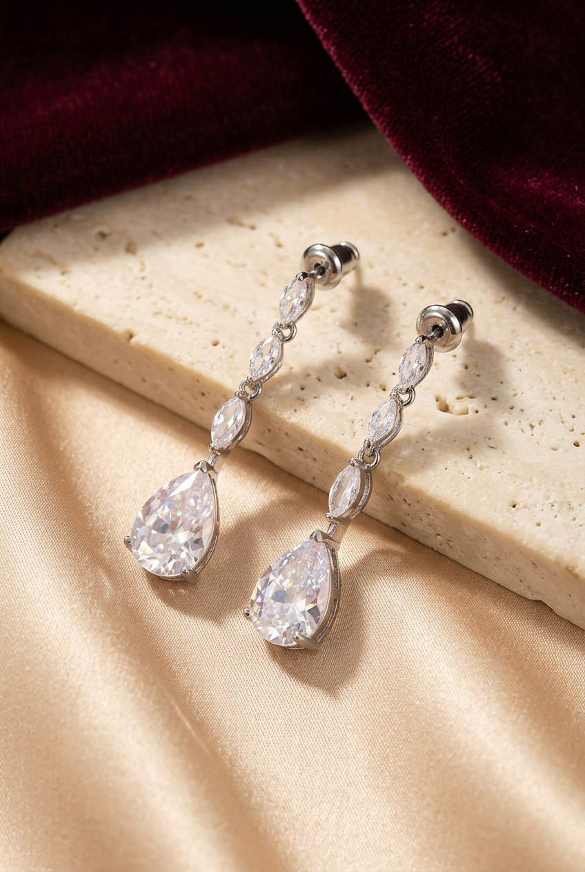 Teardrop earrings styled on champagne silk and ivory stone