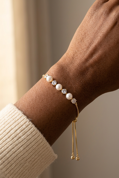 Wrist model wearing the pearl-like bead and clear-stone bracelet